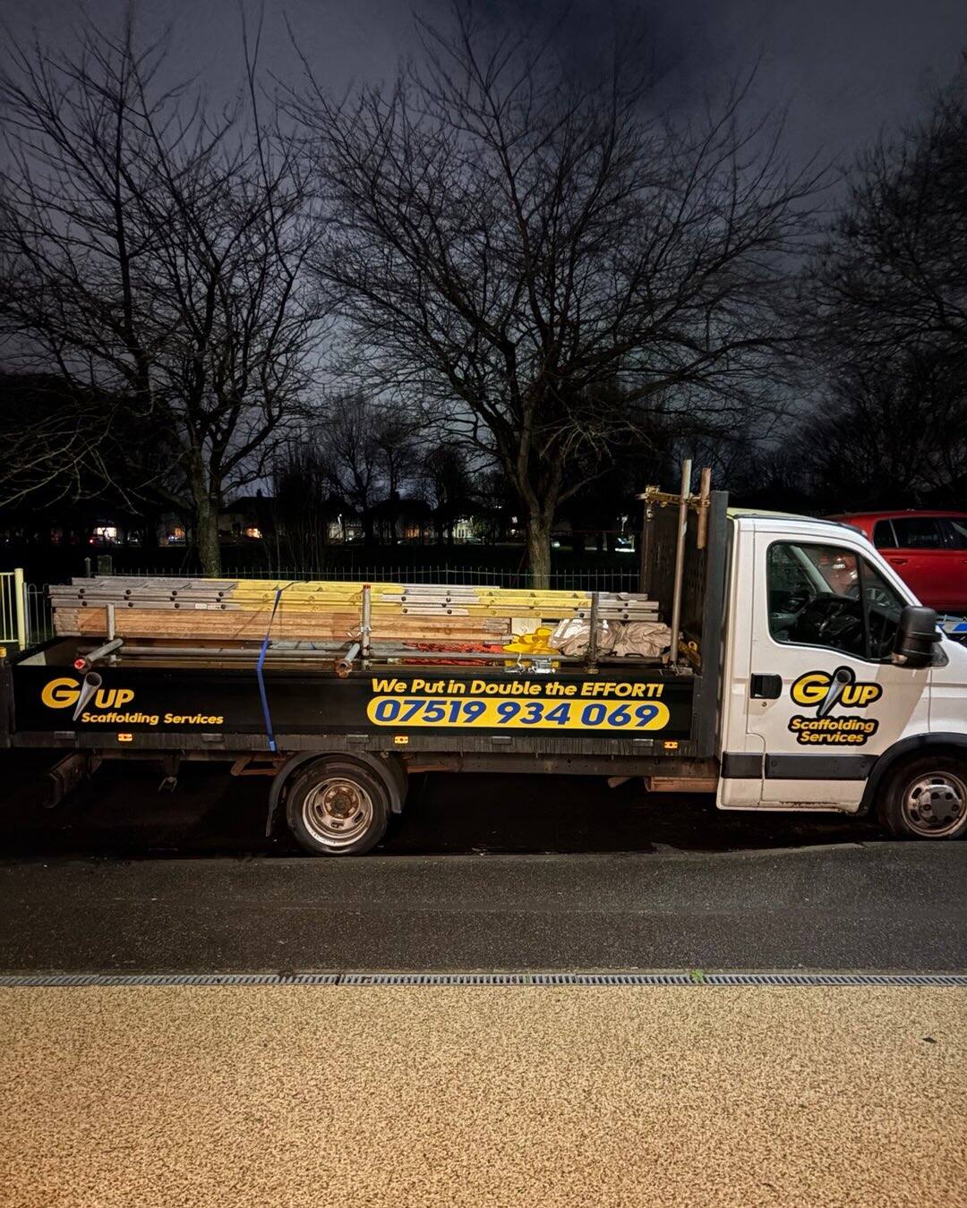 GUP Scaffolding Services flatbed truck loaded with scaffold tube and boards